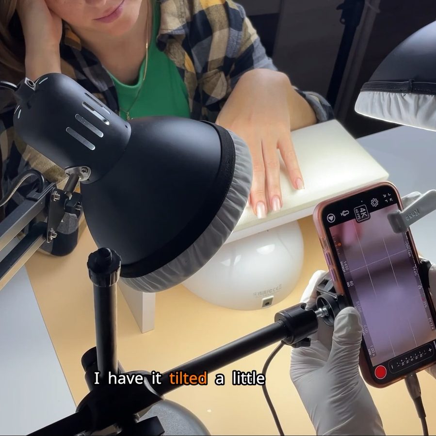 Salome filming a manicure with an iPhone rig during a live shoot