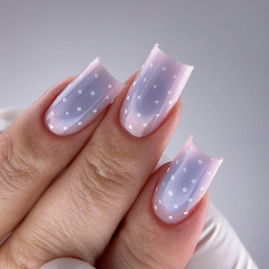 Milky polka-dot nail design shot on iPhone