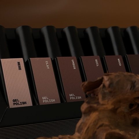 Moody product shot of a brown gel polish collection